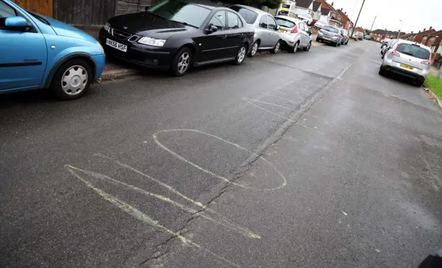 No parking graffiti on the road in Luton, near the airport