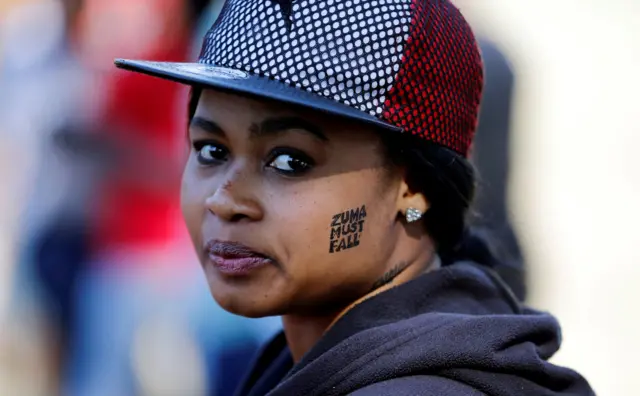 Woman with 'Zuma Must Fall' written on her face
