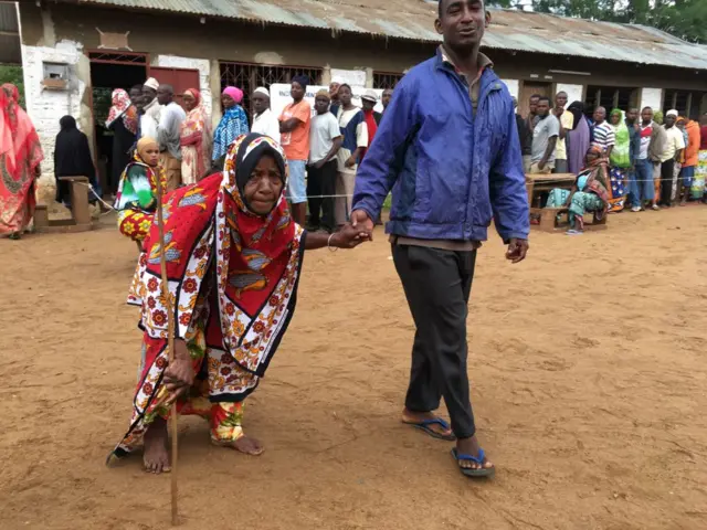 Woman being helped to vote