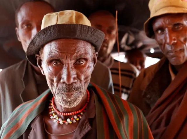 Elderly Turkana tribesman waits to vote in front of a polling station during election in a village near Baragoy