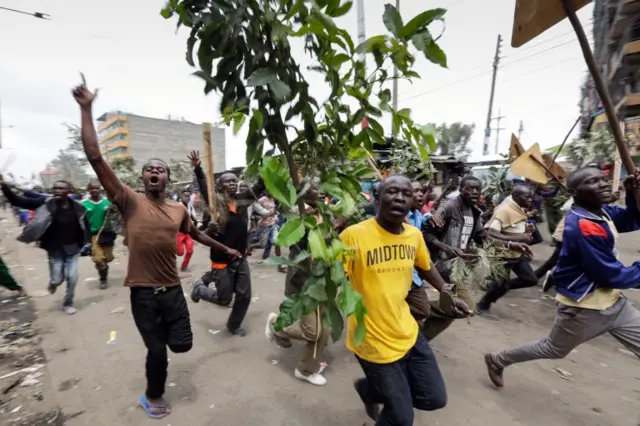 Supporters of the opposition leader Raila Odinga, who leads The National Super Alliance (NASA) coalition, shout slogans during a protest after Odinga announced that he rejects the provisional result of the presidential elections announced by the electoral body, in Mathare slums