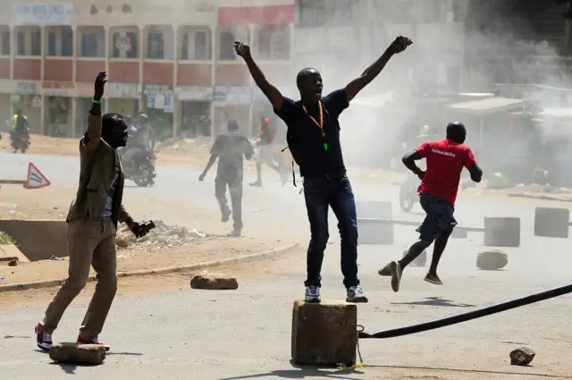 Supporters of Kenya"s National Super Alliance (NASA) shout slogans as they set fire to barricades in Kisumu on August 9, 2017,