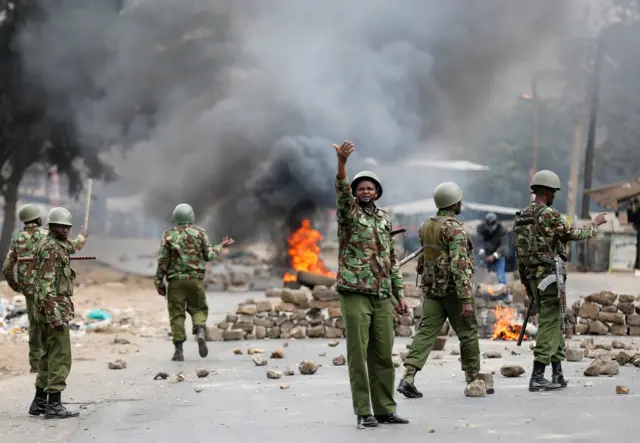 Anti riot policemen deploy after protesters set tyres on fire in Mathare, Nairobi, Kenya August 9, 2017.