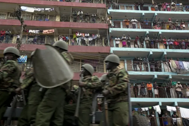 Residents on balconies watch Police units as they patrol in Mathare slums to boost security amidst violent protests that have ensued as the final votes from Kenya"s general election are counted in Nairobi, Kenya, 09 August 2017