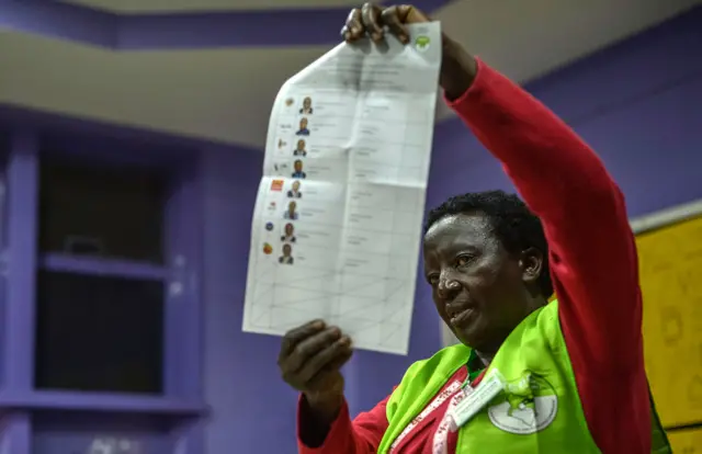 An electoral Commission official counts ballots at a polling station in Nairobi on August 8, 2017