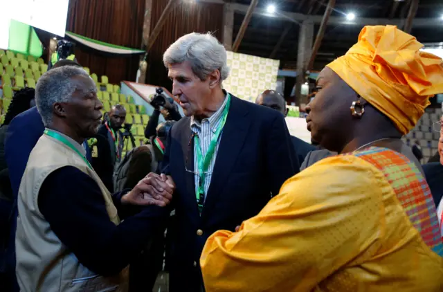 Former U.S. Secretary of State John Kerry and former South Africa President Thabo Mbeki, observers for the general election in Kenya, greet each other next to former Senegalese Prime Minister Aminata Toure