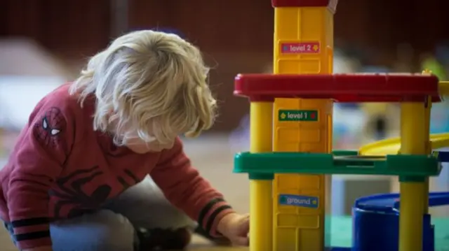 A child playing in a nursery