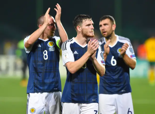 Andy Robertson applauds fans at full-time