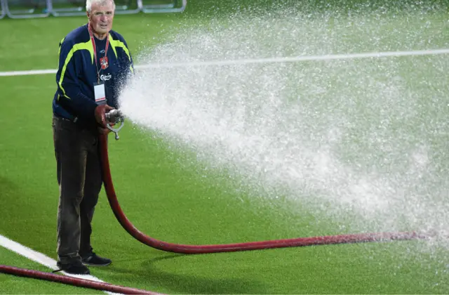 A groundsman keeps the pitch moist and everyone cool in Vilnius