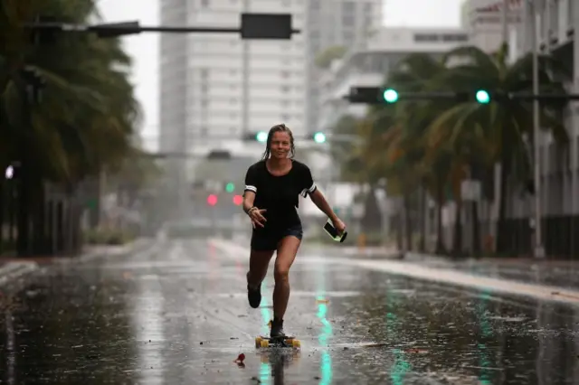 A local resident rides a skateboard before the arrival of Hurricane Irma to south Florida, in Miami Beach, Florida