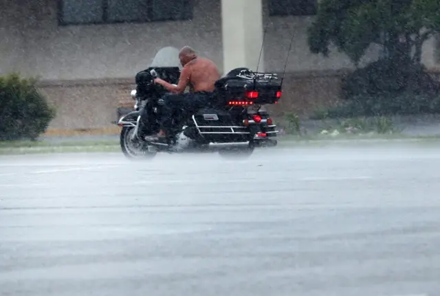 A man rides a motorcycle through the wind and rain as Hurricane Irma arrives into southwest Florida on September 10, 2017 in Bonita Springs, Florida.