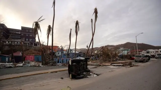 A car on its side amid the wreckage in the British Virgin Islands