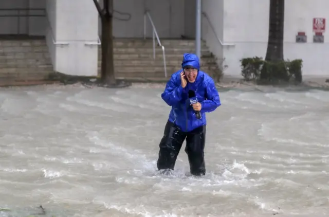 Meteorologist Mike Seidel of the The Weather Channel fights fierce winds and flooded streets while reporting on the full effects of Hurricane Irma"s strike in Miami,