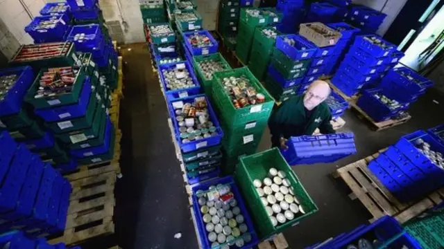 A volunteer packing items for a food bank