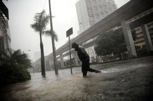 This man was wading across a flooded street in Miami on Sunday