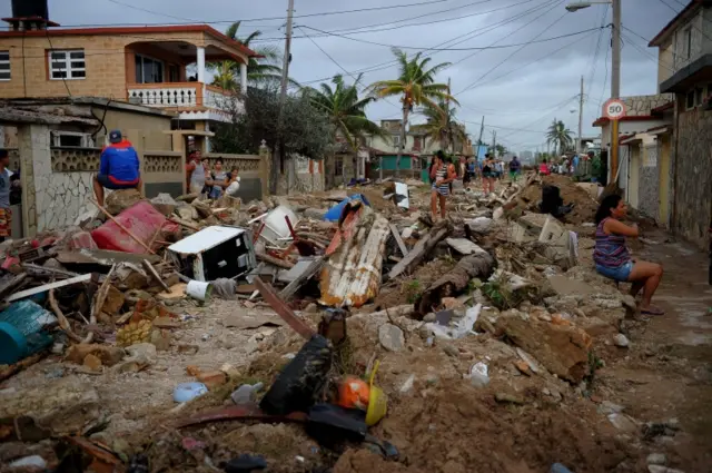 Residents walk amid debris in Cojimar neighborhood in Havana, Cuba. Photo: 10 September 2017