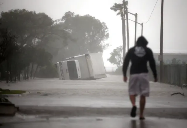 A truck is seen turned over as Hurricane Irma passes in Miami.