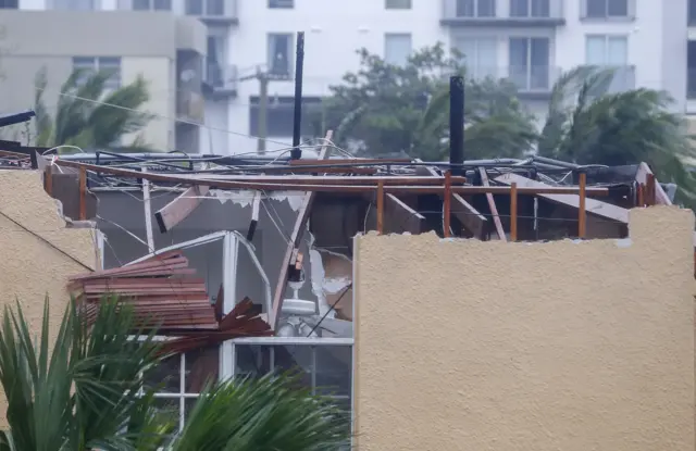 A home with severe roof damage in Miami, Florida.