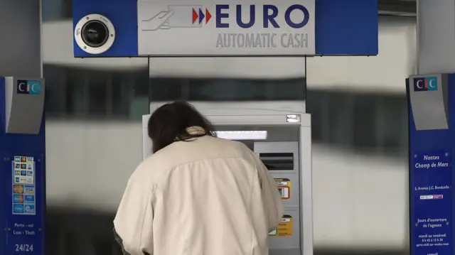 A man withdraws money from an ATM