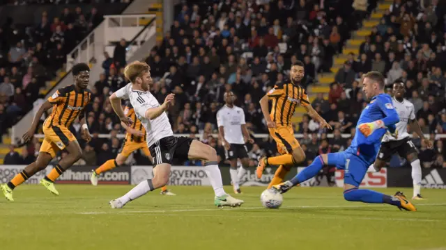 Goalkeeper Allan McGregor of Hull City saves at the feet of Tim Ream of Fulham