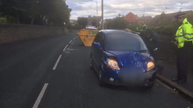 Car crashes into skip