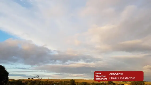 Early morning sky and clouds over open land