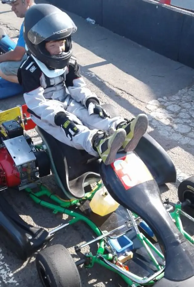 Matthew seated on go-kart