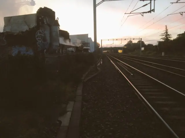 Train line and fire damaged building