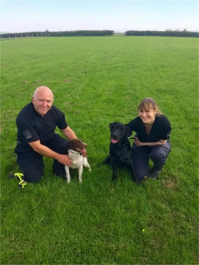 Tweed and Rob with their handlers