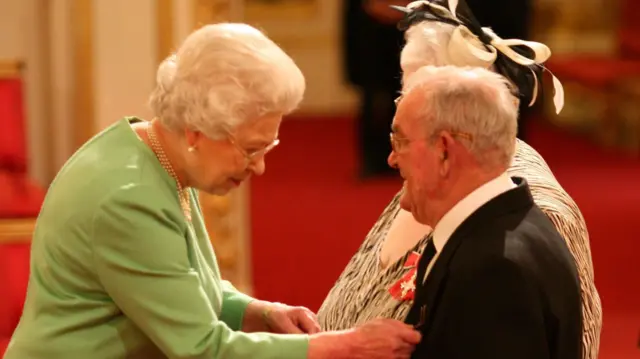 Penelope and Ronald Jones receive their MBEs from the Queen