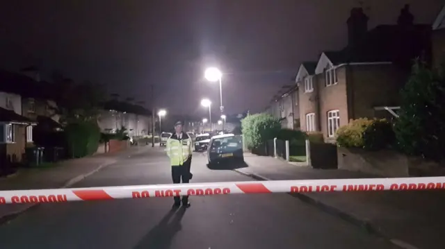 Police officers taking part in an operation in Cavendish Road, Sunbury-on-Thames, Surrey