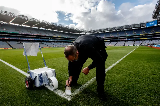 A member of the ground staff painting the lines at Croke Park