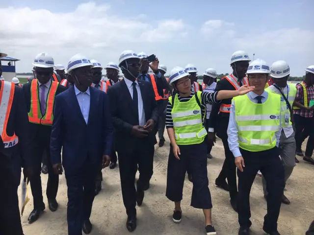 Men being shown around the port