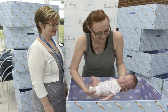 Consultant midwife Helen Smith with baby Lily with mother Sarah Pawsley