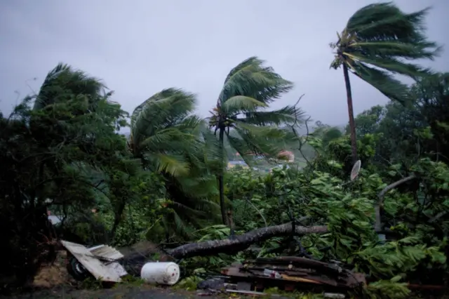 A picture taken on September 19, 2017 shows the powerful winds and rains of hurricane Maria battering the city of Petit-Bourg on the French overseas Caribbean island of Guadeloupe