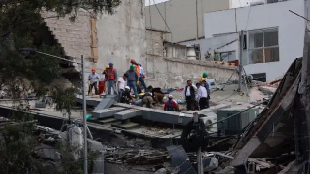 People clear rubble after an earthquake hit Mexico City, Mexico September 19, 2017