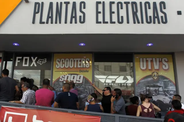 A line of customers waits for the arrival of generators at a power sports store as Hurricane Maria approaches in San Juan, Puerto Rico