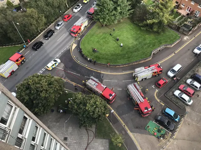 View from inside flats down to emergency vehicles