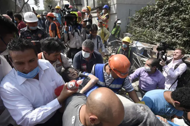 A woman is pulled from rubble in Mexico City, 19 September