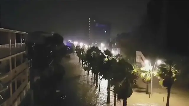 This handout picture released on September 19, 2017, on the Instagram account of "loly_fwi" shows the powerful winds and rain of hurricane Maria battering the Faidherbe boulevard along the City House (L) of Pointe-a-Pitre on the French overseas Caribbean island of Gaudeloupe