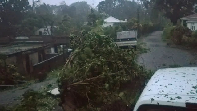 A picture taken on September 19, 2017 shows the powerful winds and rains of hurricane Maria battering the city of Petit-Bourg on the French overseas Caribbean island of Guadeloupe