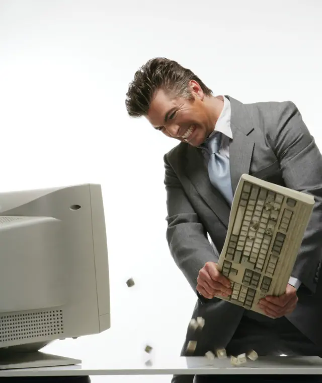 Man smashing a computer