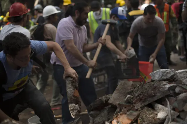 Rescuers work in the rubble after a magnitude 7.1 earthquake struck in Mexico City, Mexico, 19 September 2017