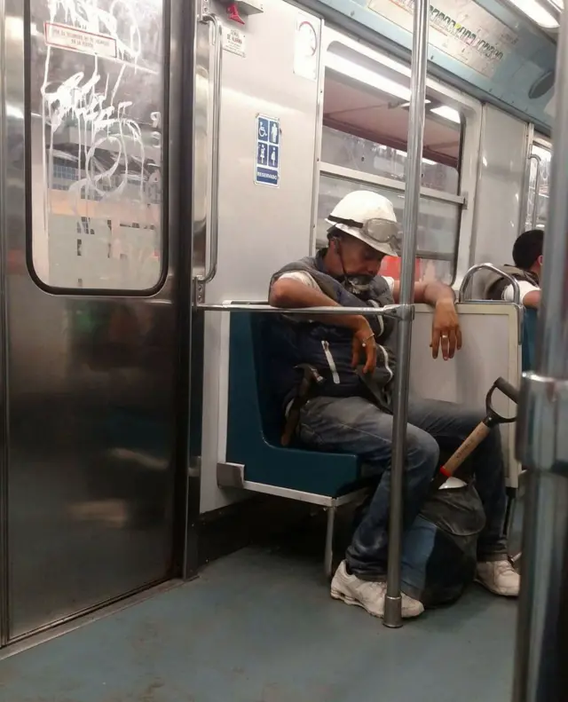 A rescue worker sits in Mexico City's metro