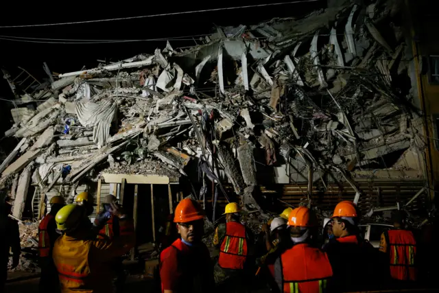 Rescue workers at the scene of a collapsed building in Mexico City