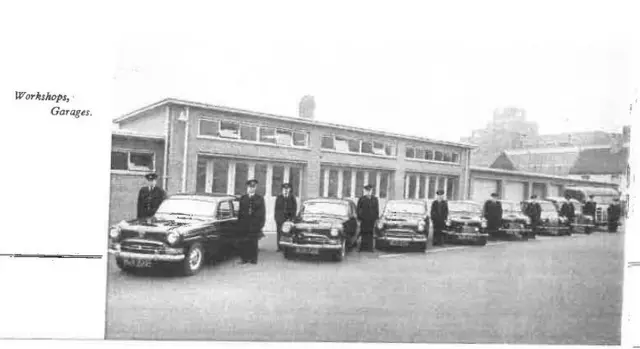 A row of policemen next to their police cars in front of Grimsby Police Station.