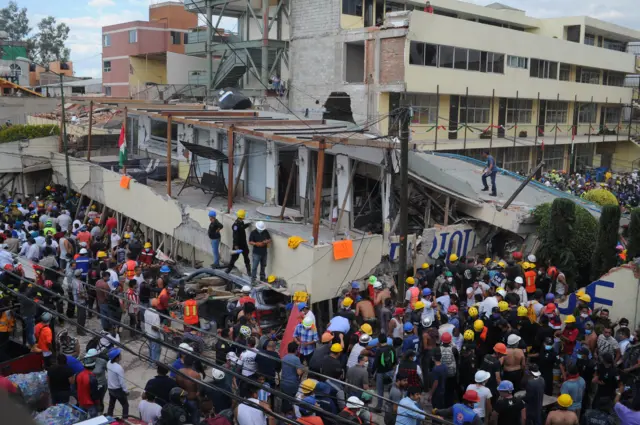 Rescue team members work at the Enrique Rebsamen school after a 7.1 magnitude earthquake, in Mexico City, Mexico, 19 September 2017