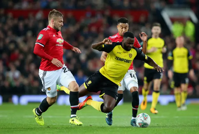 Lloyd Dyer is tackled by Luke Shaw