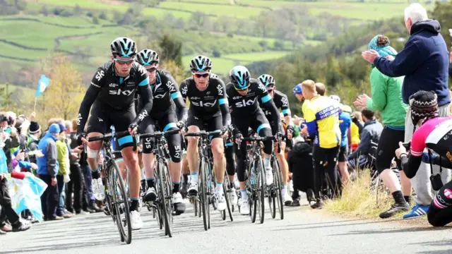 Team Sky cycling up a hill.