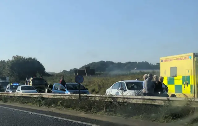 People standing by their vehicles